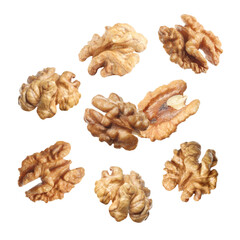 Halves of walnuts falling on white background