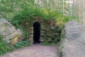 The entrance to Ossian's Cave at the Hermitage (woodland walking area) located near Dunkeld, Perthshire, Scotland.  The cave is a Georgian Folly. - 457536266