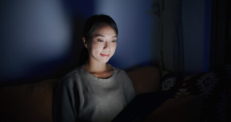 Woman use of tablet computer at home in the evening