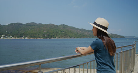 Fototapeta na wymiar Woman enjoy the sea view in countryside