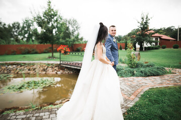 Happy wedding couple walking in a botanical park