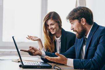 managers in the office in front of a laptop career work officials