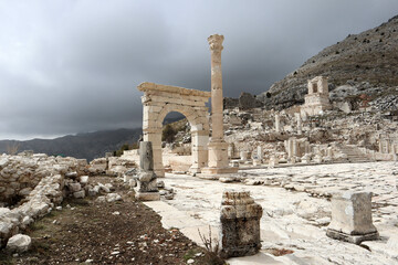 white marble arch gates among the ruins of ancient city Sagalassos in Turkey mountains