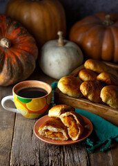 Naklejka na ściany i meble Pumpkin patties. Autumn food. You are on the table. A treat for Halloween. Still life. Sweet pastries with filling. Pie.