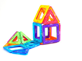 Magnetic construction kit for the development of motor skills and imagination. The model of the house is assembled. Revenge for text.