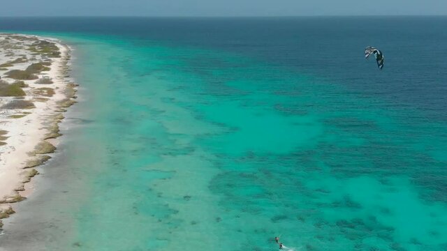 Drone view of the two kiteboarders sailing on the beautiful tropical sea 