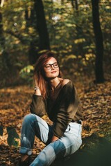 autumn photo session of a beautiful girl with dark hair in the forest.