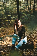 autumn photo session of a beautiful girl with dark hair in the forest.