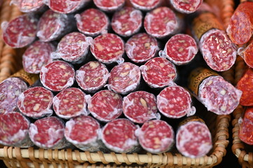 Many salami sausages in foil on a market in Berlin-Germany.