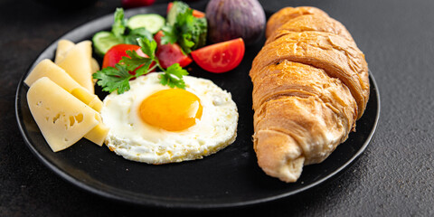 breakfast fried eggs and a cup of coffee liquid egg yolk fresh portion ready to eat meal snack on the table copy space food background rustic. top view keto or paleo diet veggie or vegetarian