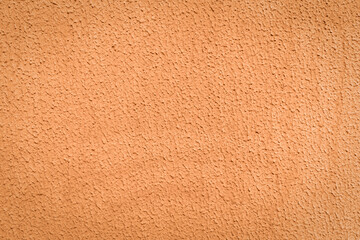 brown textured surface of rough facade plaster