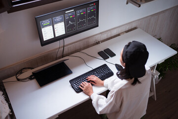 Serious ethnic female trader analyzing cryptocurrency market statistics