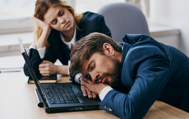 colleagues sitting at a desk with a laptop communication technologies