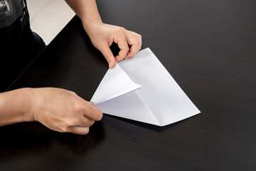 A woman is folding paper.