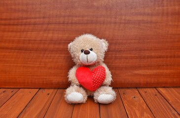 A small teddy bear with red heart.  Valentine's day 