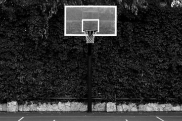 Red basketball hoop with net. Monochrome photography. Sport concept