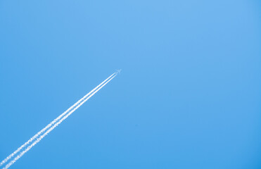 airplane flying high in the blue sky
