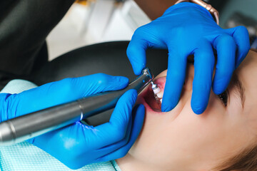 Happy kid in clinic doing dental treatment. Dentist orthodontics.