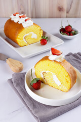 Bolu Gulung or Roll Cake, is an Indonesian version of Swiss roll. A fluffy soft sponge cake rolled with butter cream and garnish with strawberry.