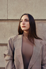 Pensive lady against a wall in deep thought