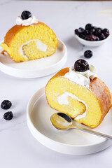 Bolu Gulung or Roll Cake, is an Indonesian version of Swiss roll. A fluffy soft sponge cake rolled with butter cream and garnish with blueberry.