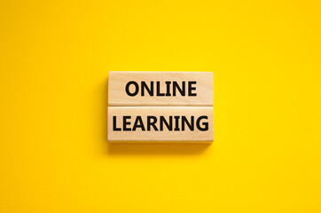 Online learning symbol. Concept words 'Online learning' on wooden blocks on a beautiful yellow background. Business, educational and online learning concept, copy space.