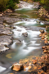 Long exposure photograph of a river in the council of Aller in Asturias.The photo is shot in vertical format and the water appears with the silk effect or also called silky water.