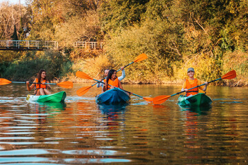 A group of friends are kayaking. Active recreation of young people in nature. Outdoor activity. Copy space