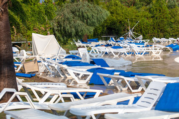 Straw loungers and sun loungers at the water park after  tornado.