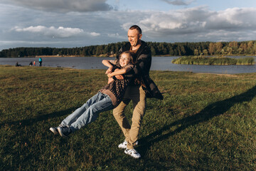 Fototapeta premium Father and daughter share love, have fun in park. Family outdoor vacation together. Happy Father's Day!