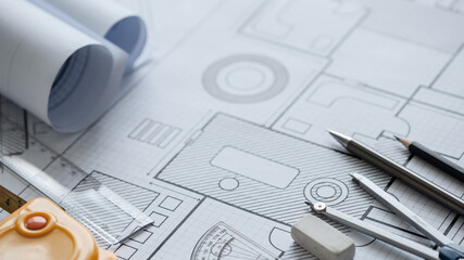 architectural blueprints and blueprint rolls and pencils pen, ruler, protractor, and tape measure...