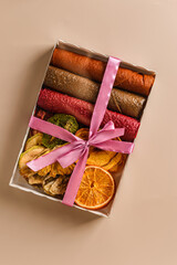pastilles and dried fruits on a beige background