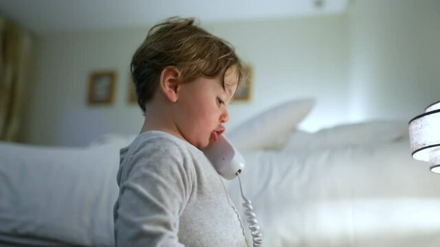 Baby talking on phone. Funny adorable cute baby with phone in ear
