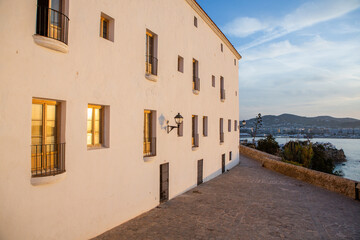 The architecture of the island of Ibiza. A charming empty white street in the old town of Eivissa