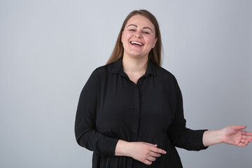 Laughing young plus size model. Overweight woman having a good laugh in camera. Fat young female in...
