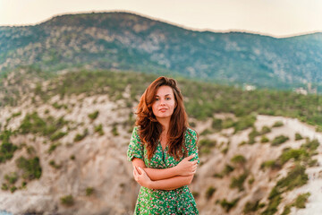 A beautiful young woman in a dress on Cape Kapchik in the Crimea. Romantic seascape