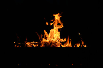 flames at night. Fire flames on black background.  tongues of flame on the background of coals