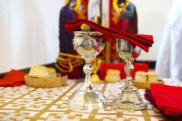 Orthodox faith. Gold and silver bowls for communion are covered with a red cloth on the throne of...