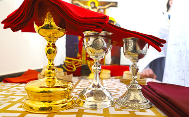 Orthodox faith. Gold and silver bowls for communion are covered with a red cloth on the throne of...