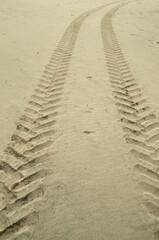 Two traces of tractor tires in sand