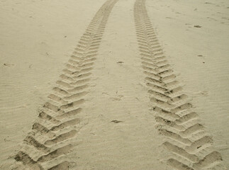 Two traces of tractor tires in sand