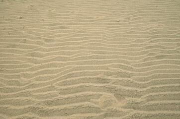 Fototapeta na wymiar Beautiful wavy beach sand close