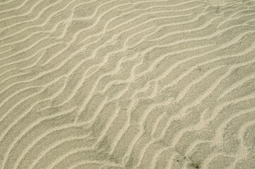 Fototapeta na wymiar Beautiful wavy beach sand close