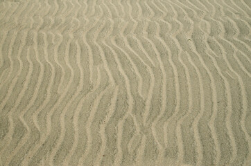 Beautiful wavy beach sand close
