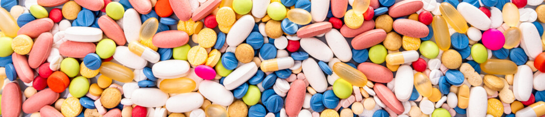 Close up of variety of colorful pills, capsules, and tablets