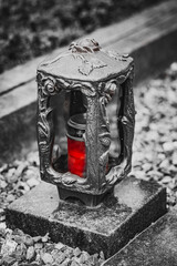 Old damaged grave lantern on a gravestone