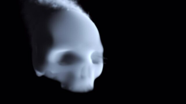 Floating smoke skull. Sinister skull made of smoke floating on black background. Alpha channel.
