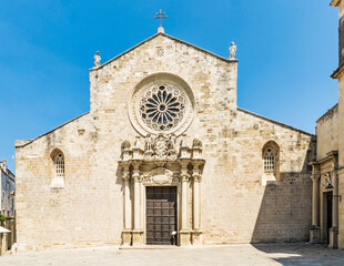 Fototapeta na wymiar The façade of the Cathedral of Otranto, with statues and a rose window made by Leccese sandstone, in Otranto, province of Lecce, Salento, Puglia, Southern Italy 