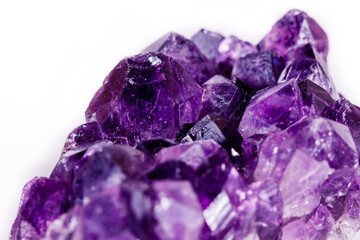 Fototapeta premium Macro mineral stone purple amethyst in crystals on a white background