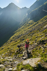 Fototapeta na wymiar Woman hiker with backpack on a trail in the mountains